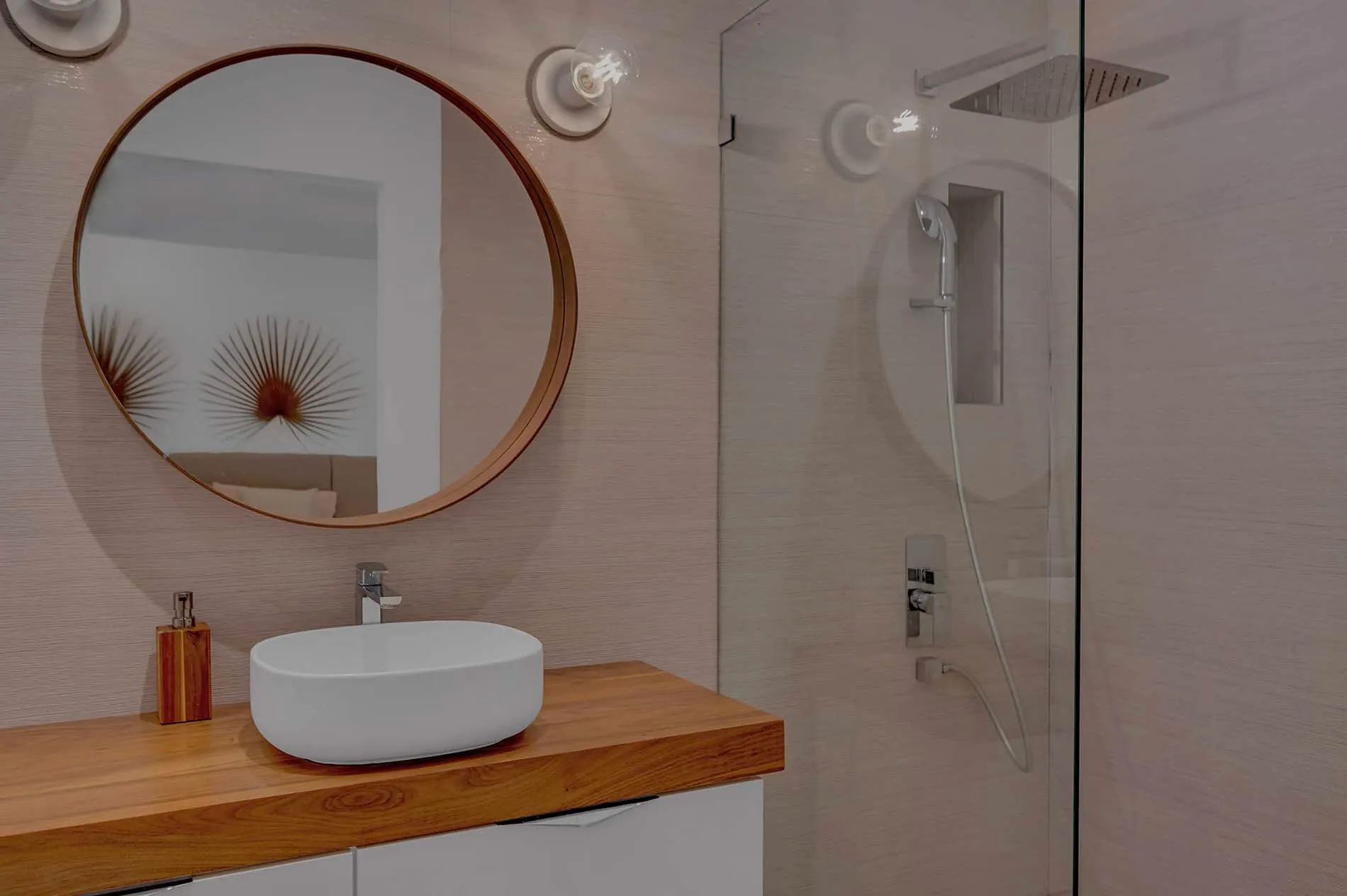 Coconut Grove home renovation - main bathroom with round mirror and glass shower door, designed by Beatrice Leupold