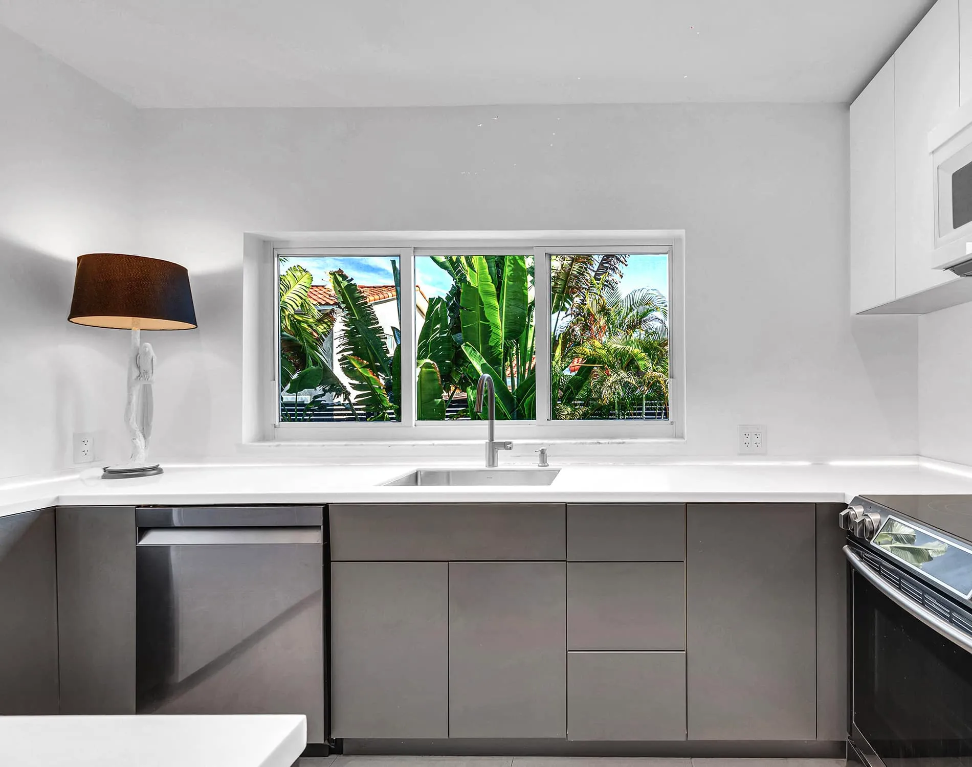 Coconut Grove home renovation - kitchen sink with window, designed by Beatrice Leupold
