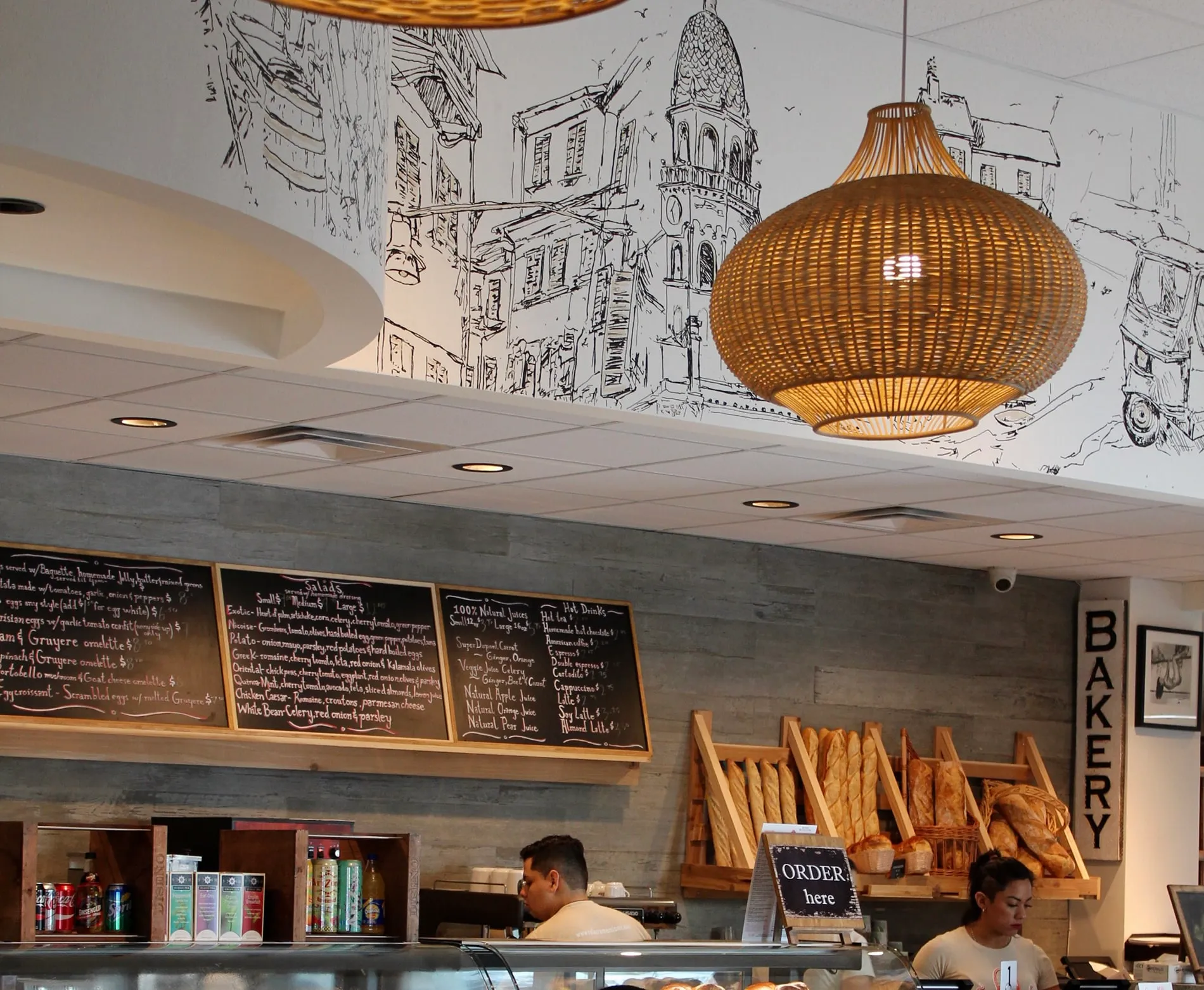 Café Crème Miami Restaurant - front counter with the menu written on boards behind it, design by Beatrice Leupold