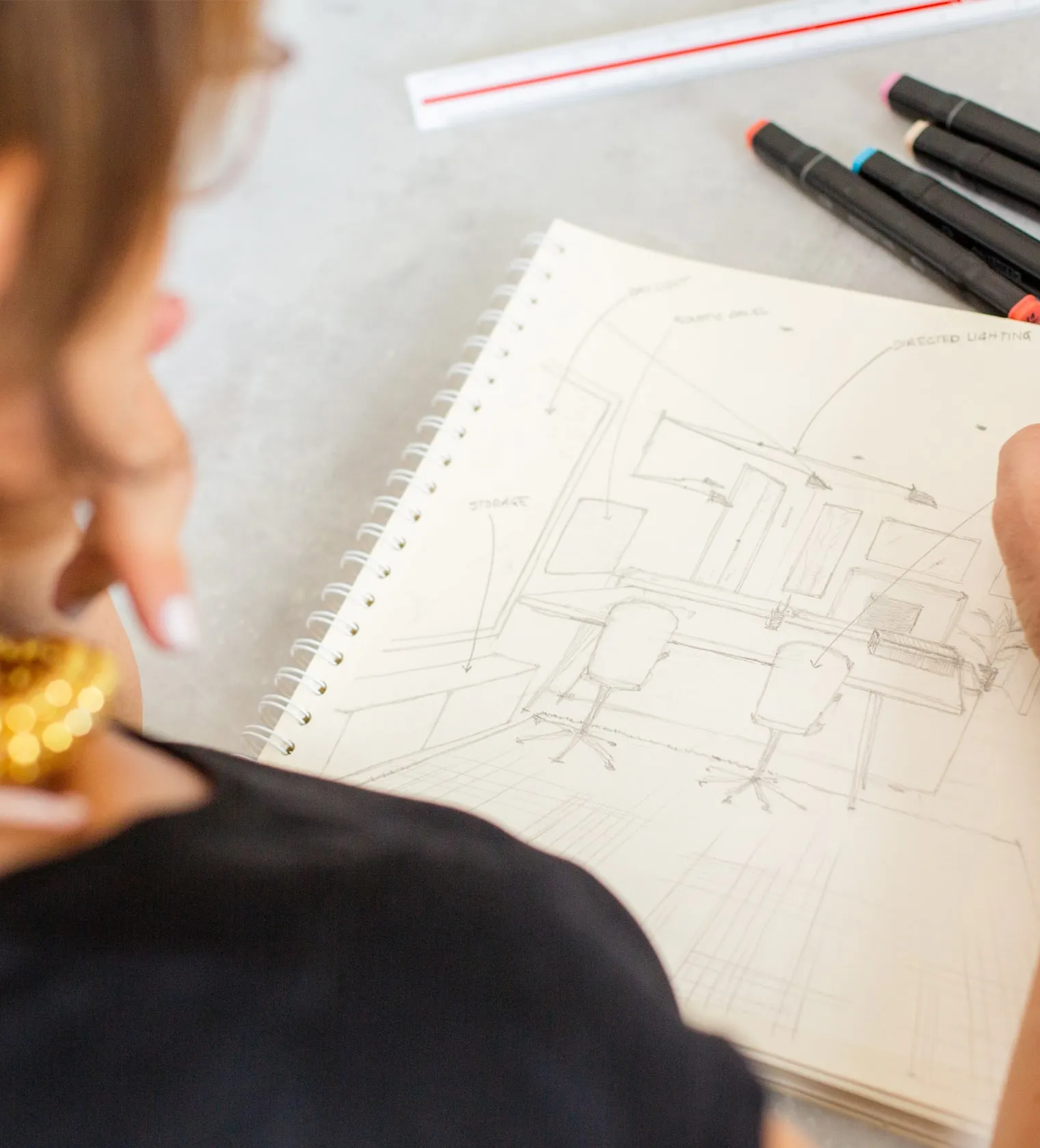 Beatrice drawing an interior design sketch