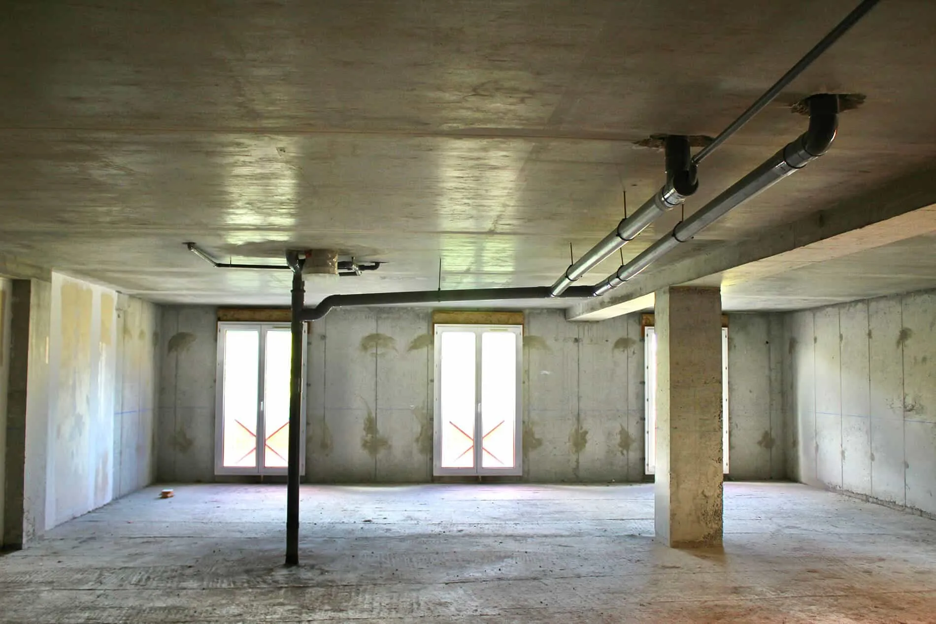Wellness clinic before image of an empty construction space with concrete floors and walls