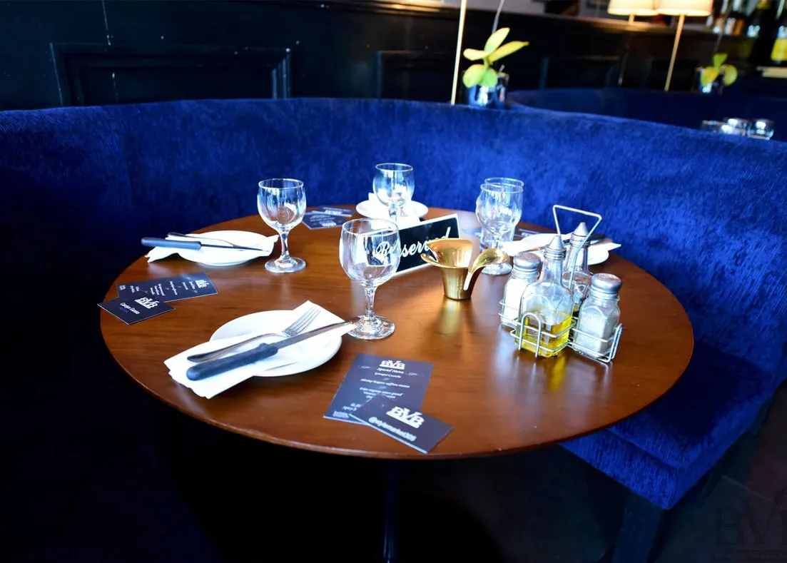 Buena Vista Bistro Restaurant - booth with a round table set, designed by Beatrice Leupold