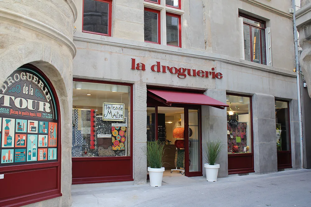 Droguerie de la Tour storefront in Saint-Étienne: the medieval tower's arched window and the red “la droguerie” façade