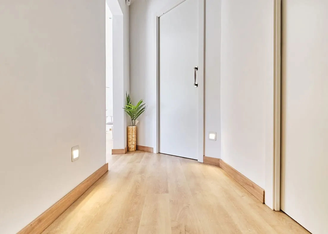 Barcelona apartment - first floor, hallway with wooden floor that leads to the bedrooms, designed by Beatrice Leupold