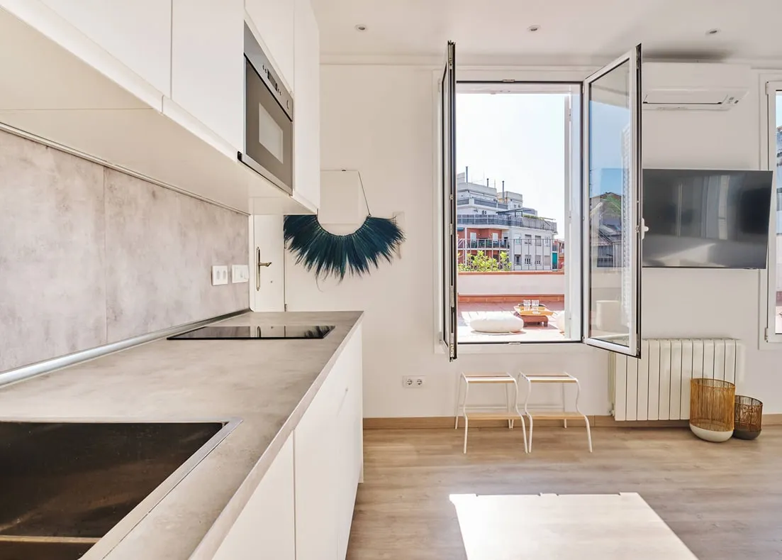 Barcelona roof studio - second-floor studio, kitchen area with glass doors that open to the roof, designed by Beatrice Leupold